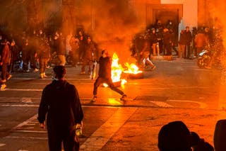Iranians gather while blocking a street during a protest in Tehran, Iran on January 9